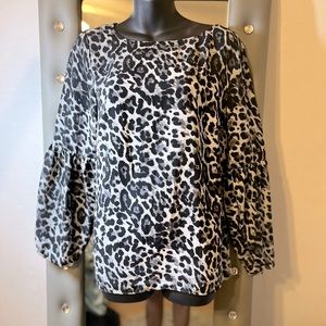 Black/white animal print top size med with a slight balloon sleeve.